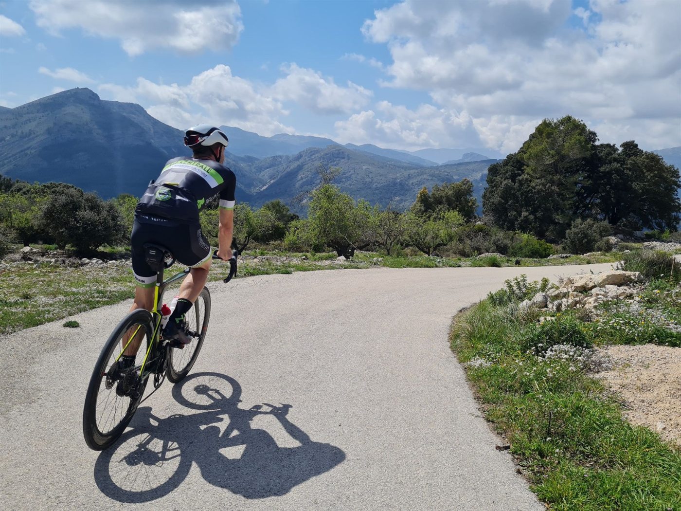 Julius Bartaševičius riding a road bike on a mountain road in Spain